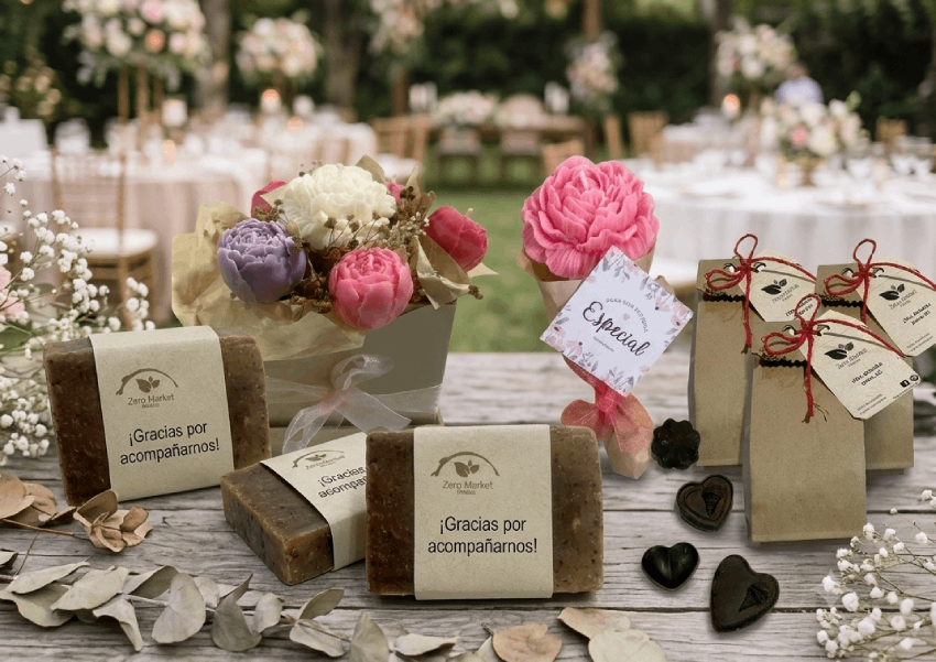 Mesa de recuerditos para eventos sociales con jabones, velas y chocolates
